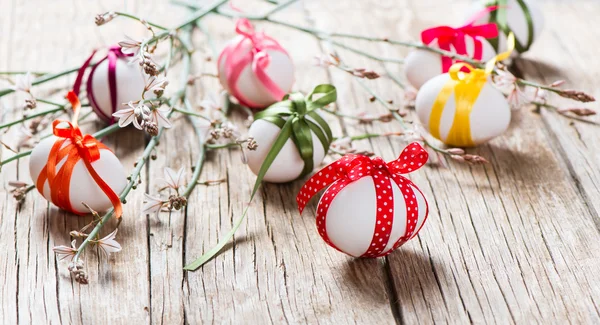 Easter eggs and branch with spring flowers — Stock Photo, Image